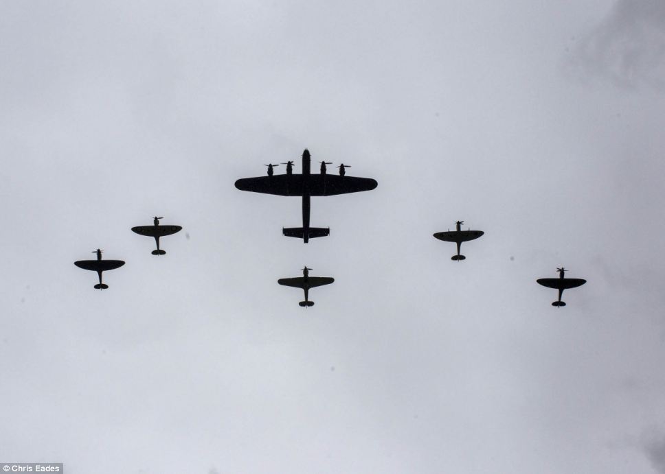 Stirring image: The Lancaster, centre, was accompanied by two Spitfires on both flanks and tailed by a Hurricane