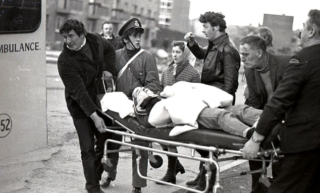 An injured protestor is stretchered away during the riots