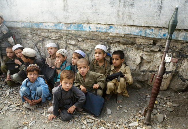 Afghan boys gather near a school in Aliabad.